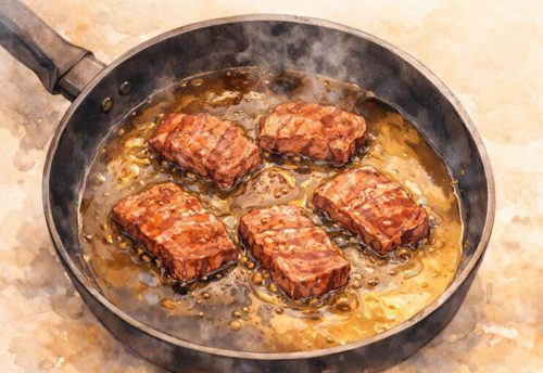 フライパンで焼き肉を焼いているイラスト